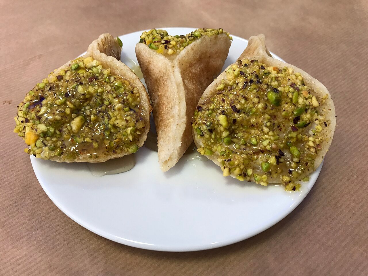 Qatayef — folded Arabic pancakes filled with cream or walnuts