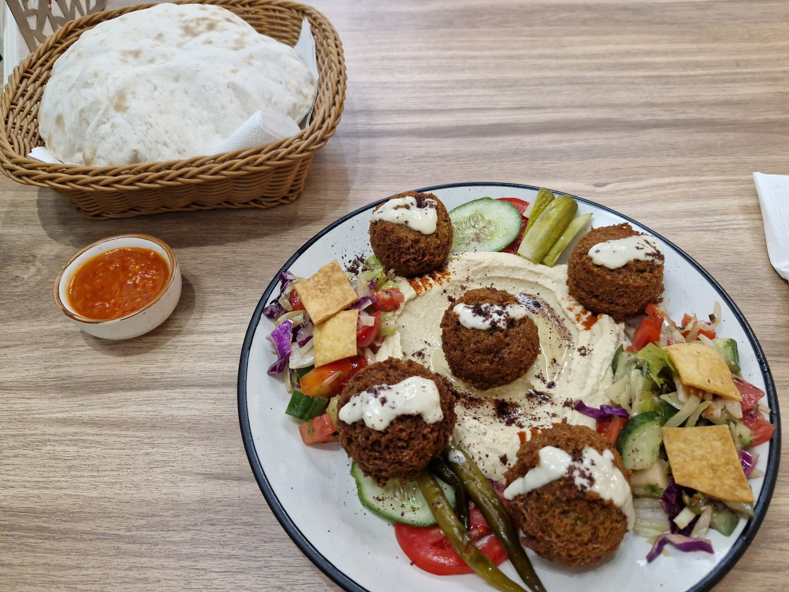 The mezze spread at Ali Baba Gżira — hummus, labneh, tabbouleh and warm bread
