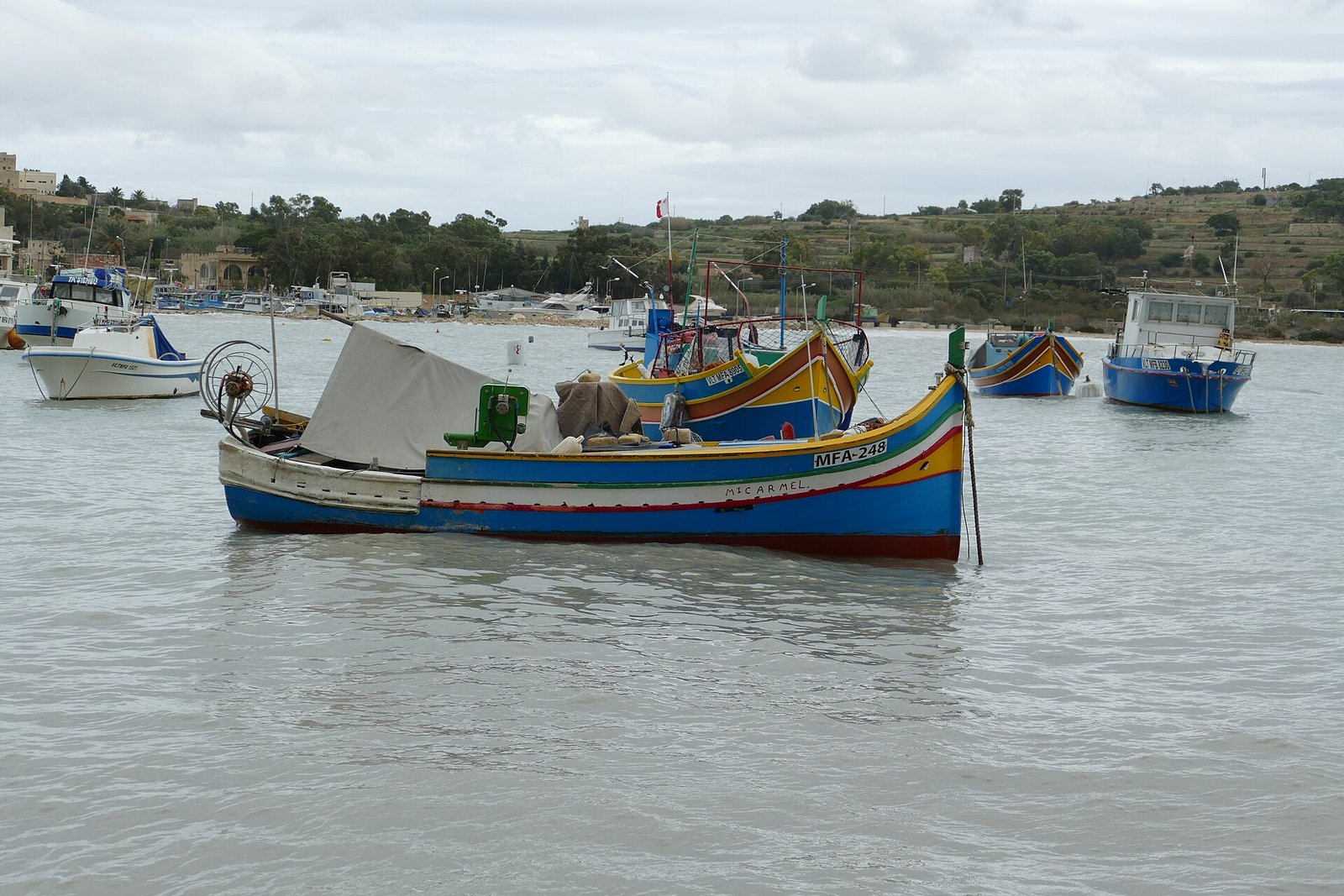 Colourful luzzu fishing boats in Marsaxlokk harbour, Malta